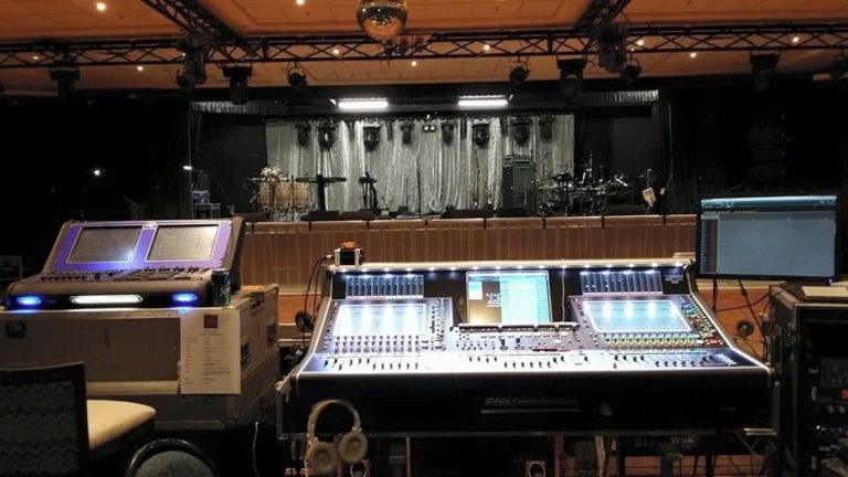 Large sound & lighting control panel with stage in background
