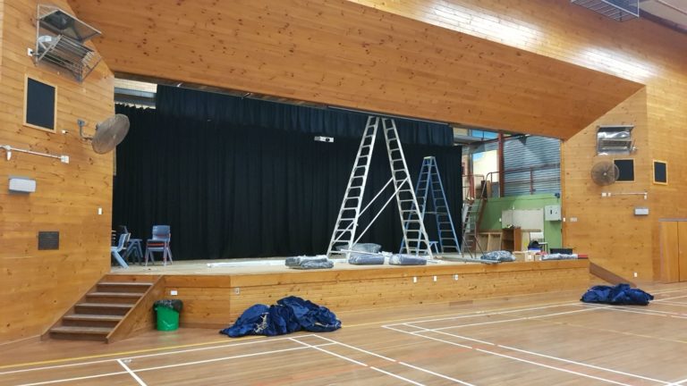 Wooden stage with lighting installation in progress